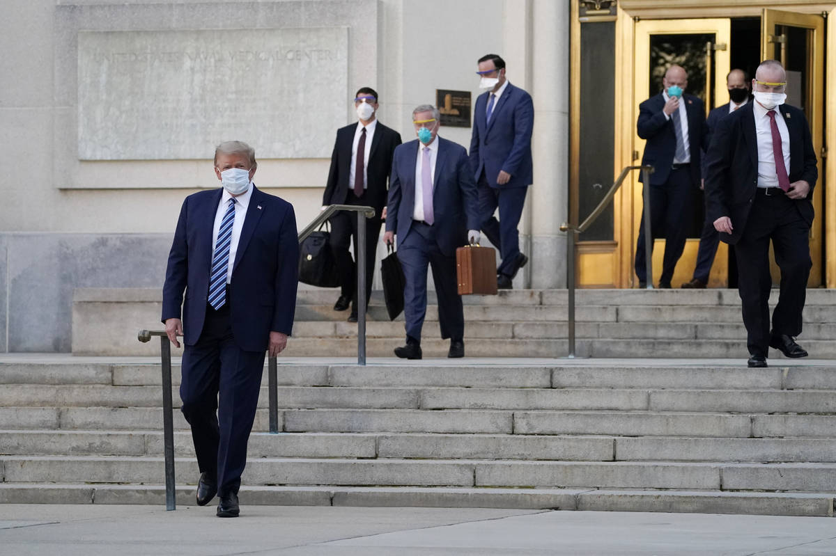 President Donald Trump walks out of Walter Reed National Military Medical Center to return to t ...