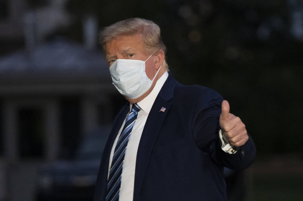 President Donald Trump gives thumbs up as he returns to the White House Monday, Oct. 5, 2020, i ...