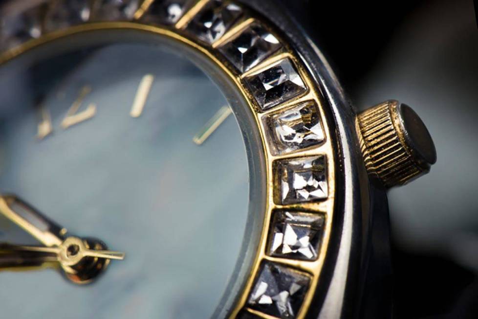 Macro close up of watch face with square diamonds around face.