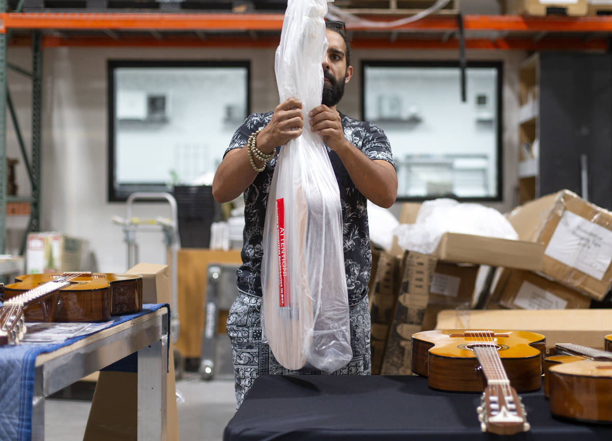 Ryan Patrick, guitarist for Las Vegas band Otherwise, unloads a shipment of guitars at Structur ...