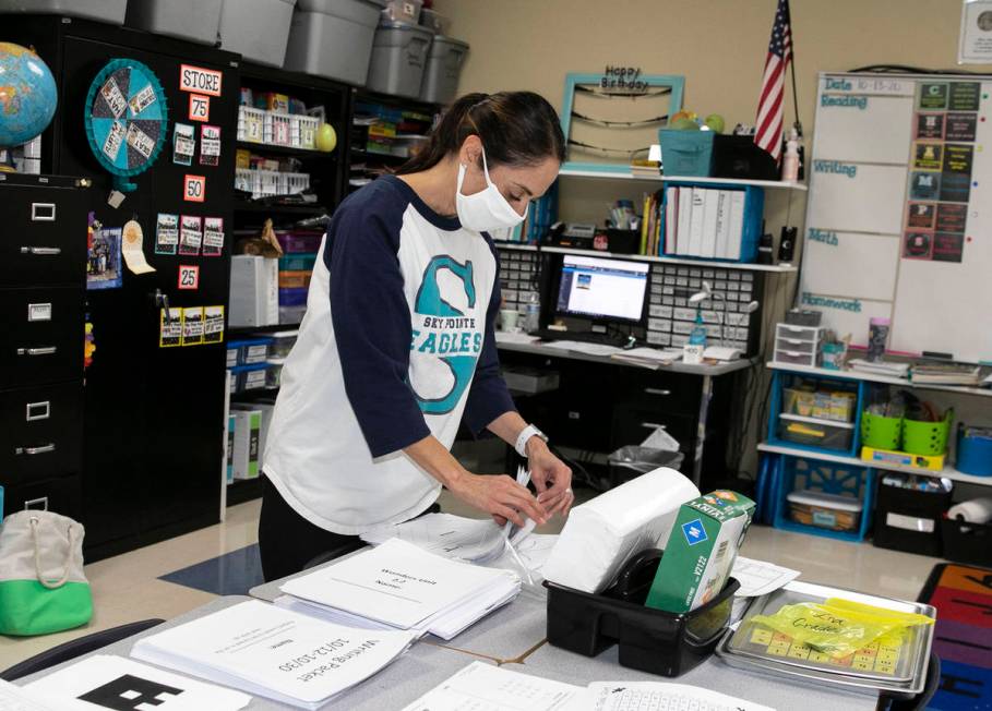 Debbie Martin, second grade teacher, sorts out worksheets at Somerset Academy Sky Pointe as she ...