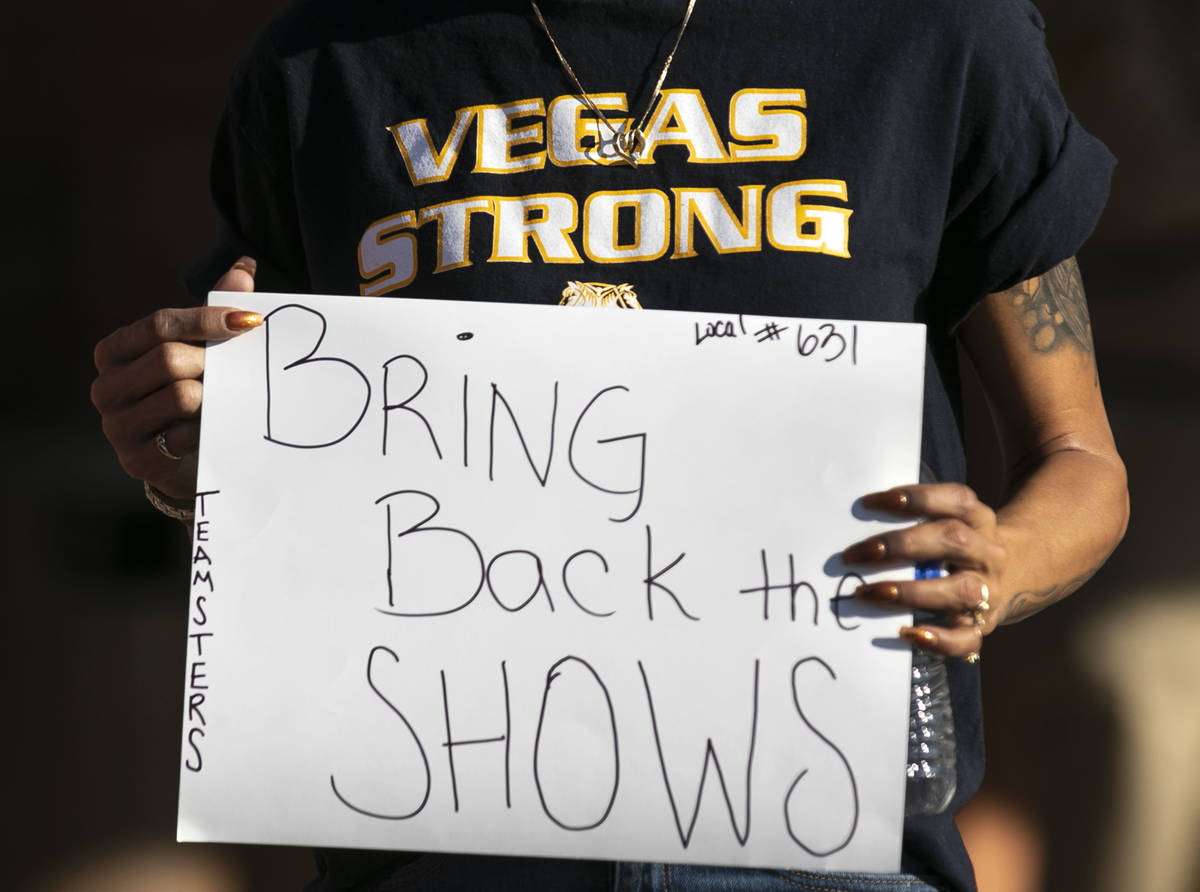 Vanessa Peck, a member of Local 631, holds a sign as she joins a rally outside of the Clark Cou ...