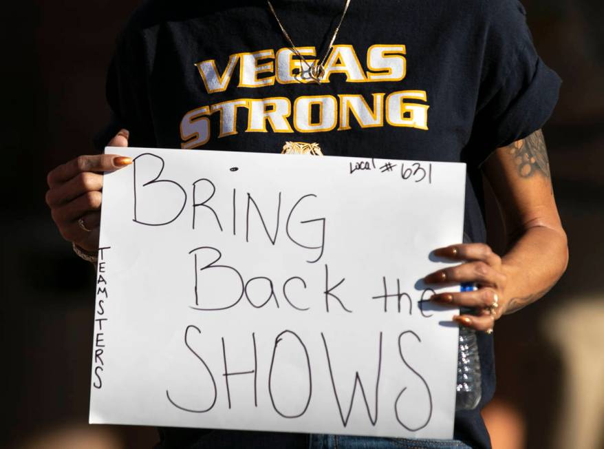 Vanessa Peck, a member of Local 631, holds a sign as she joins a rally outside of the Clark Cou ...