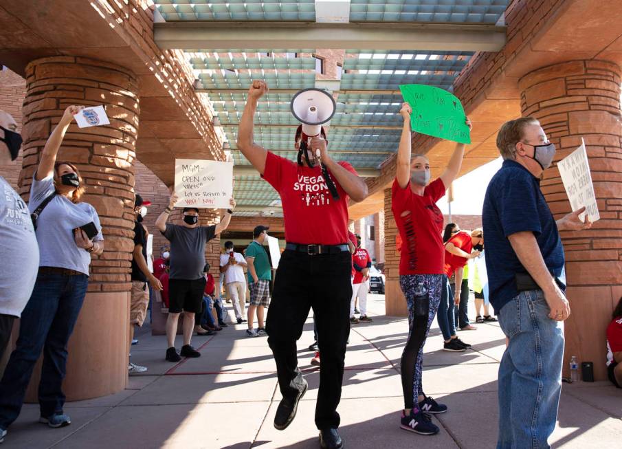 Jose Rivera, center, rally organizer, shouts slogans as he joins a rally outside of the Clark C ...