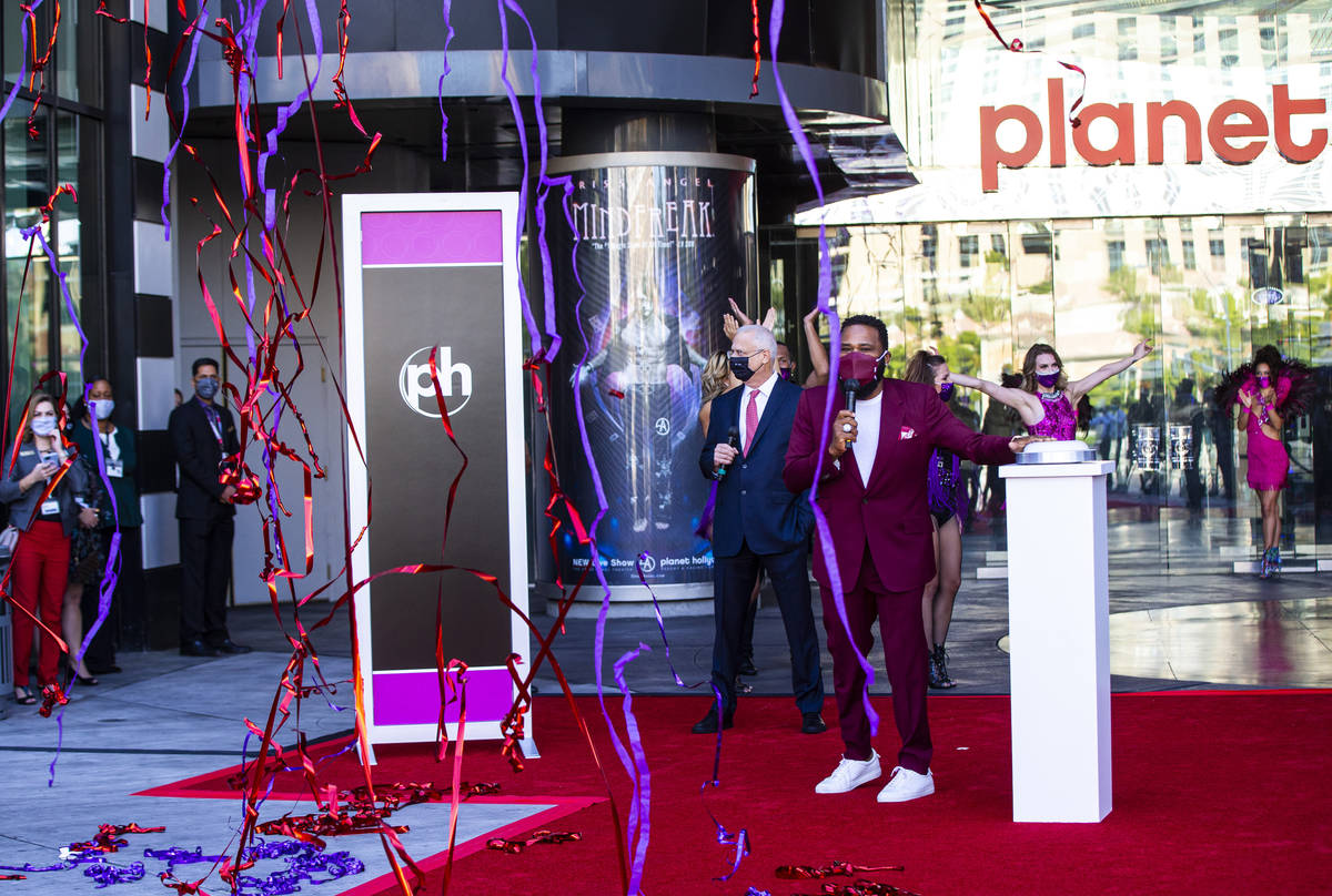Confetti and streamers fall as actor Anthony Anderson marks the reopening of the Planet Hollywo ...