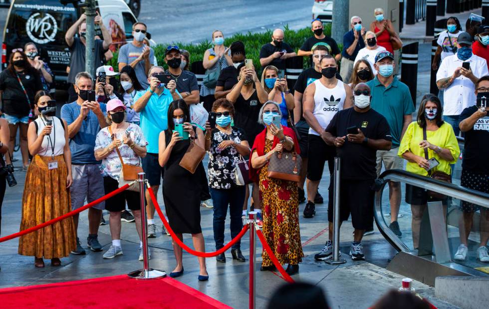 People watch as dancers perform to mark the reopening of the Planet Hollywood Resort in Las Veg ...