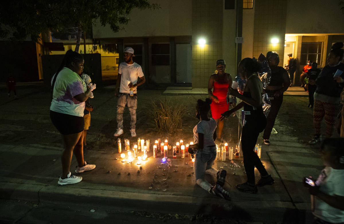 People gather by candles lit in memory of 1-year-old Sayah Deal in Las Vegas on Tuesday, Oct. 6 ...