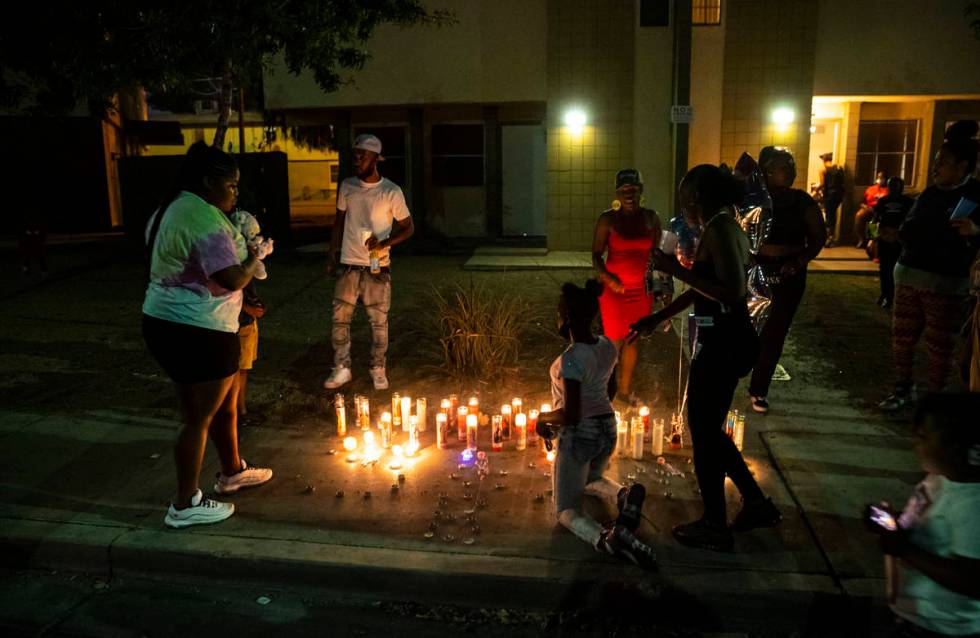People gather by candles lit in memory of 1-year-old Sayah Deal in Las Vegas on Tuesday, Oct. 6 ...