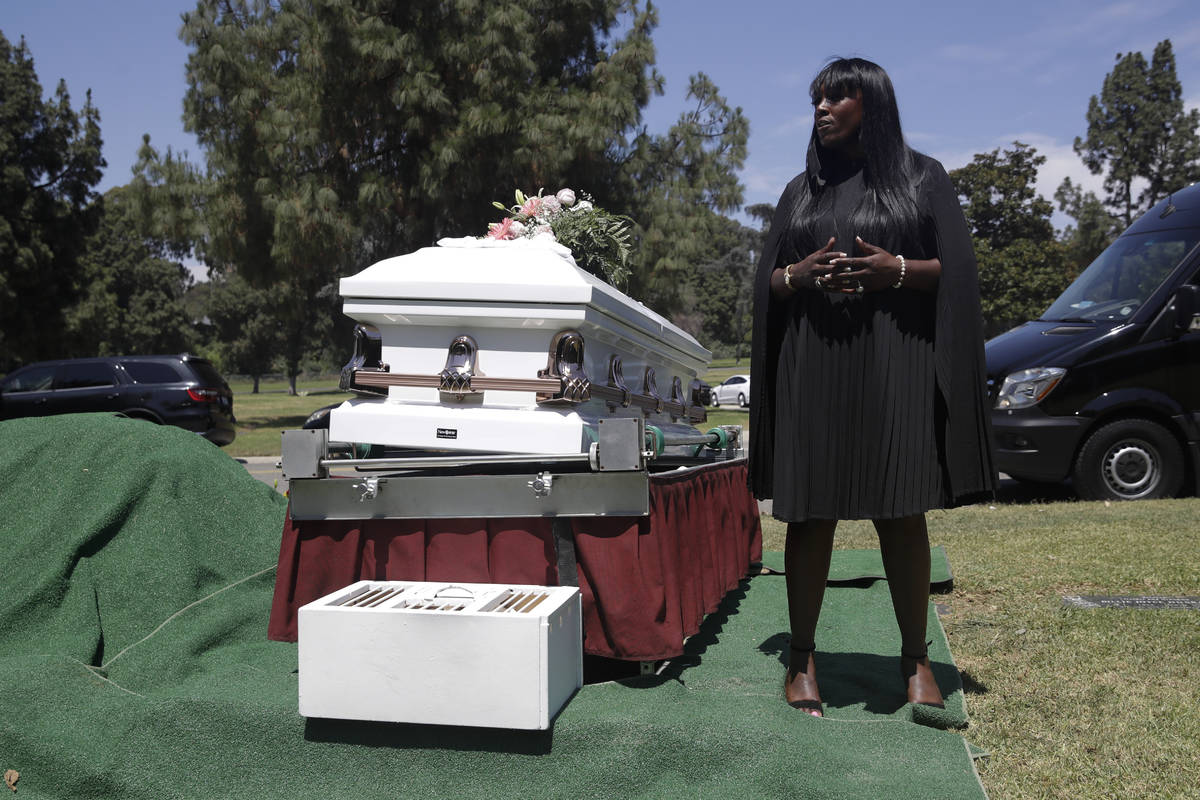 In this July 21, 2020, file photo, Candy Boyd, owner of Boyd Funeral Home, speaks to family mem ...