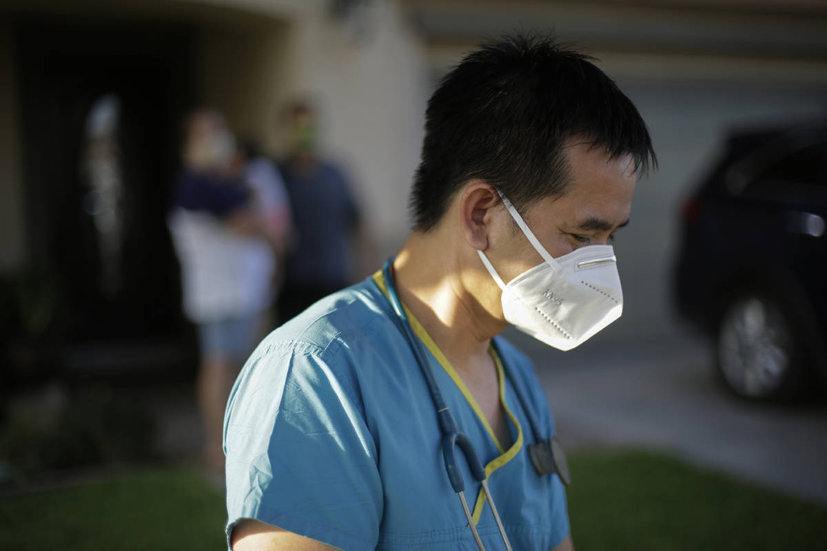 In this July 23, 2020, file photo, Dr. Tien Vo leaves after talking with a family quarantining ...