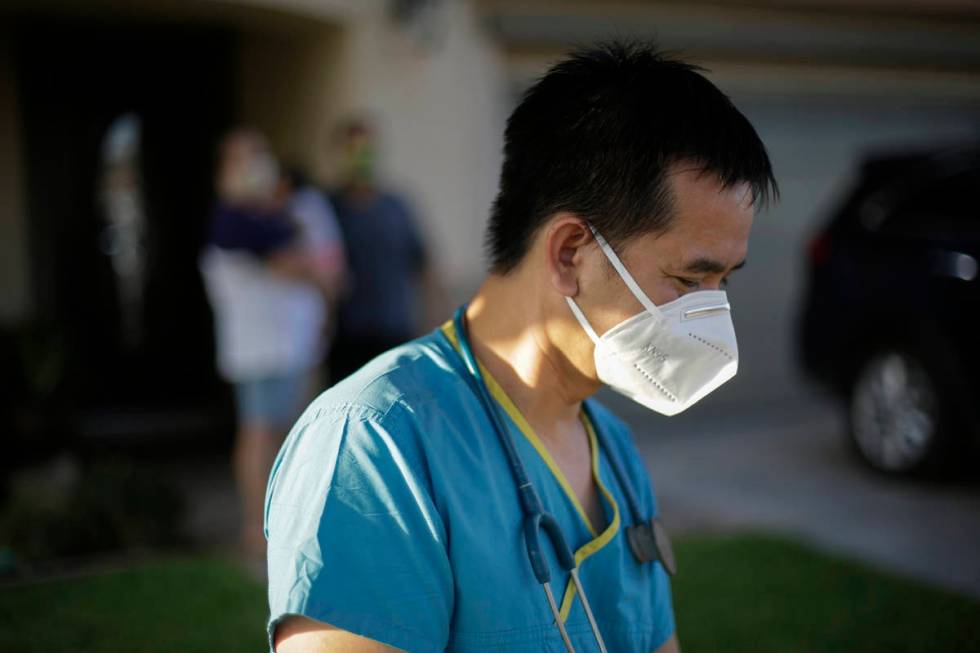 In this July 23, 2020, file photo, Dr. Tien Vo leaves after talking with a family quarantining ...