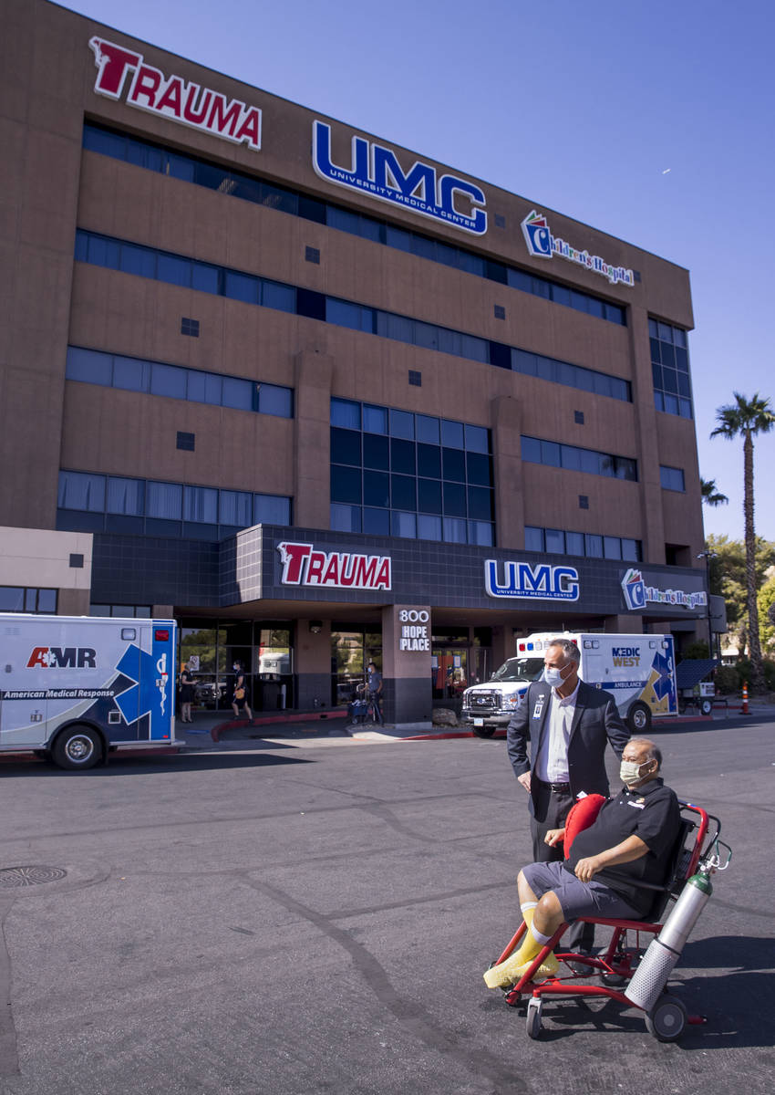 University Medical Center CEO Mason Van Houweling, above, waits with patient Pablo Bernabe as h ...