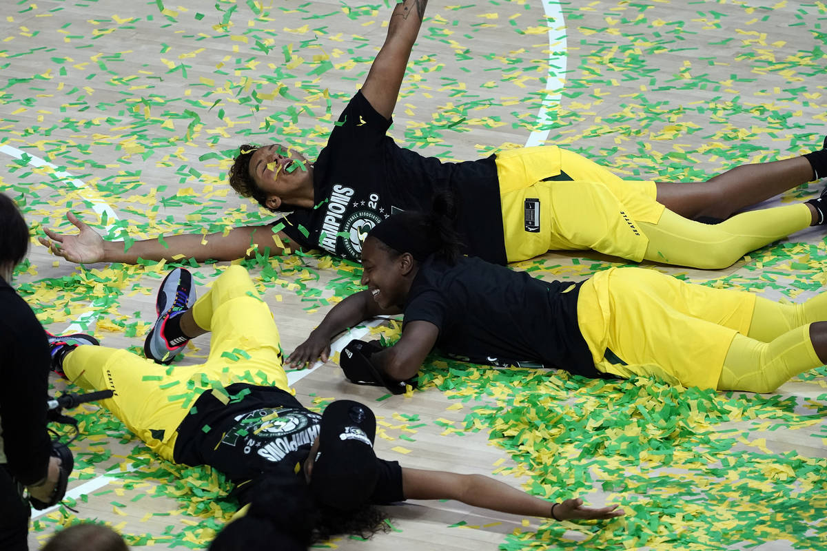 Seattle Storm players, including Mercedes Russell, top, play in the confetti after the team won ...