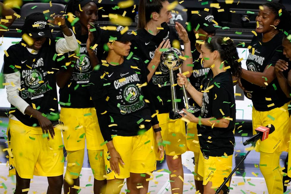 Seattle Storm guard Sue Bird shows the trophy to some of her teammates after the team defeated ...