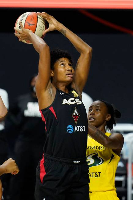 Las Vegas Aces forward Angel McCoughtry (35) grabs a rebound in front of Seattle Storm guard Je ...