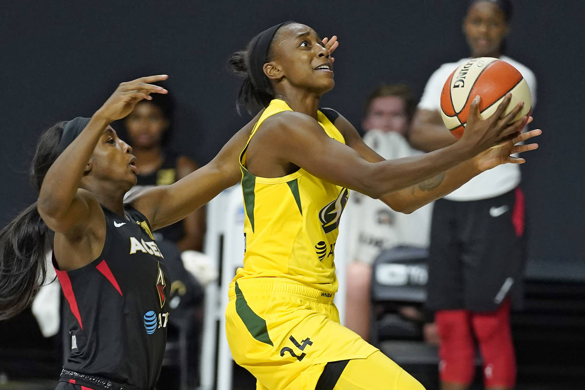 Seattle Storm guard Jewell Loyd (24) shoots after driving around Las Vegas Aces guard Jackie Yo ...