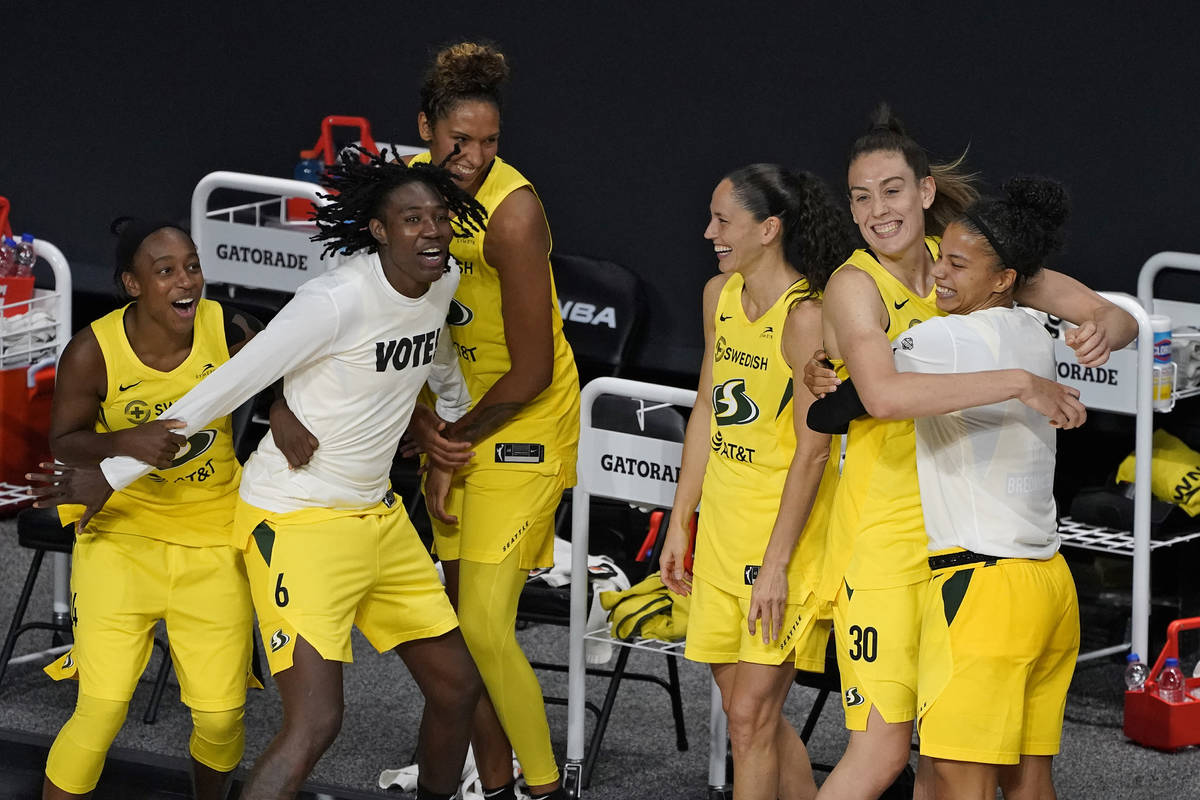The Seattle Storm celebrate after defeating the Las Vegas Aces to win the WNBA championship Tue ...