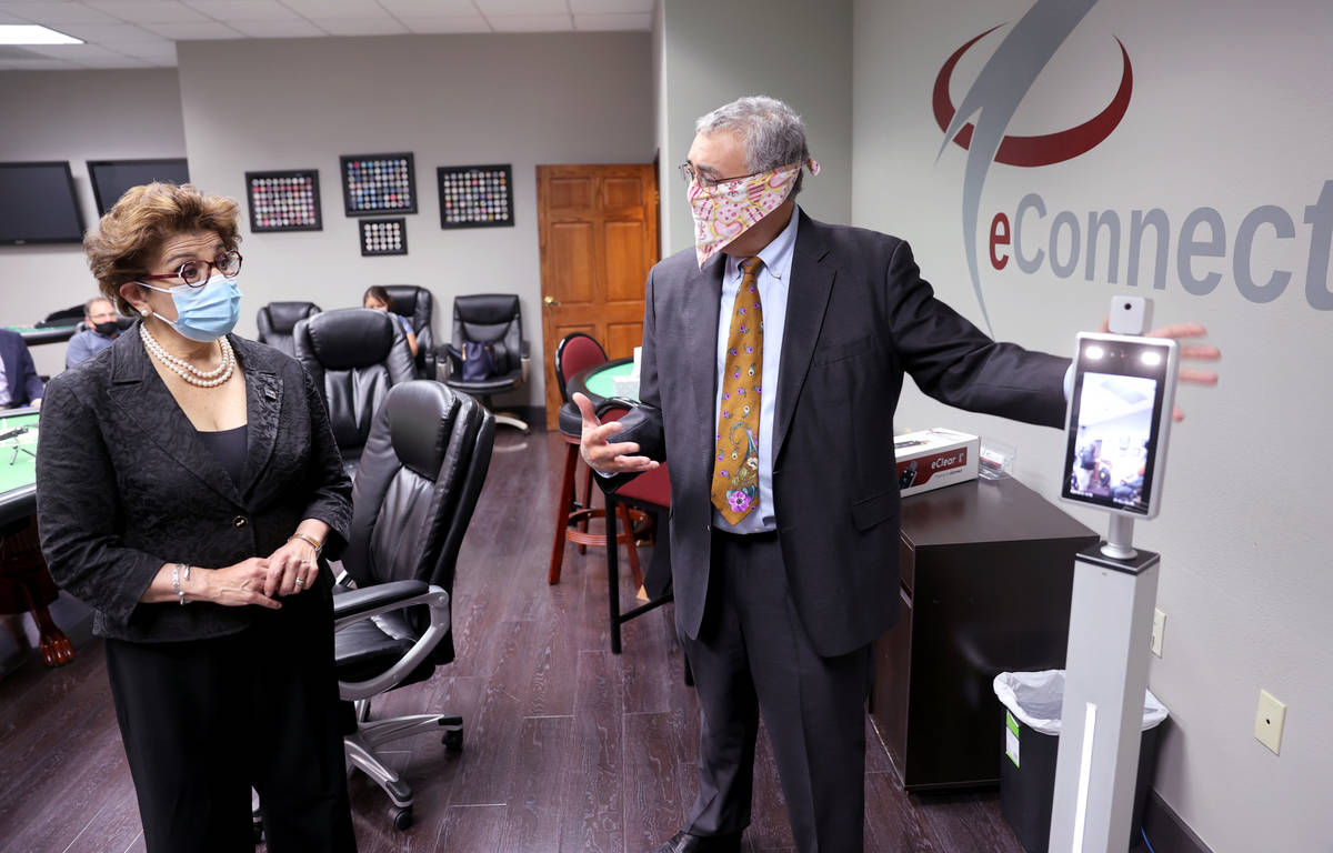 EConnect President and CEO Henry Valentino III, left, shows the eClear self-serve temperature c ...