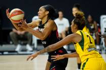 Las Vegas Aces center A'ja Wilson (22) grabs a pass while being guarded by Seattle Storm center ...
