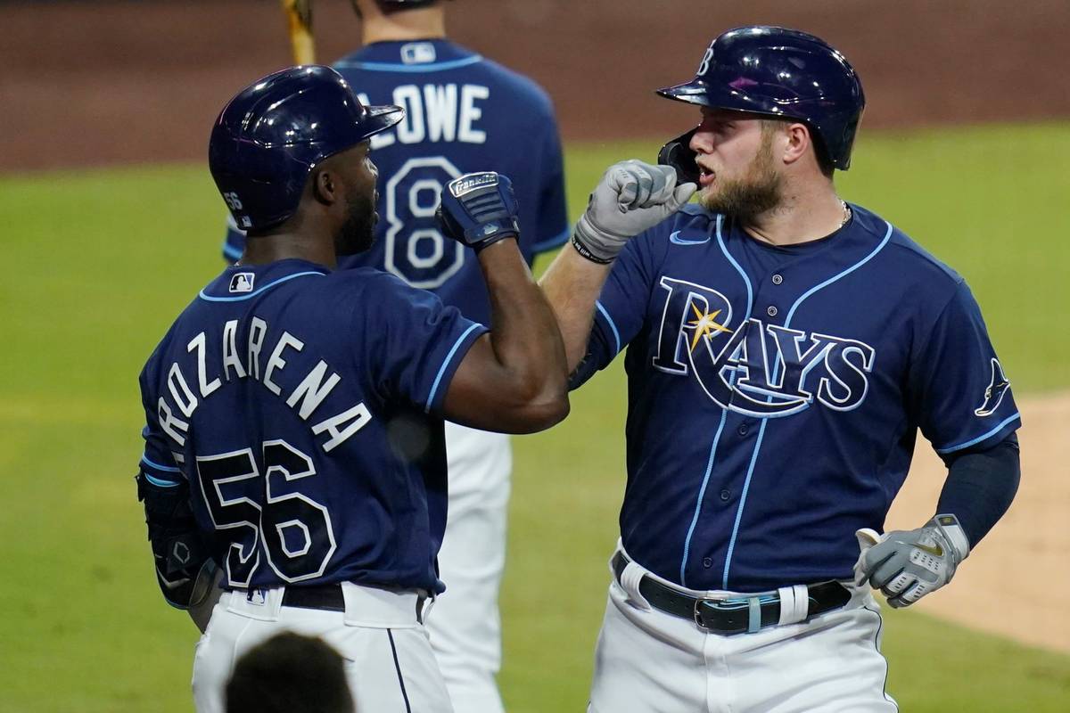 Tampa Bay Rays' Austin Meadows, right, greets Randy Arozarena after Meadows hit a solo home run ...