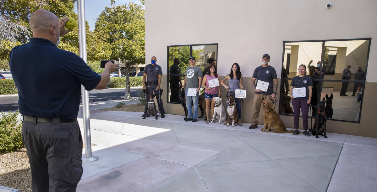 Trainer Cameron Ford with Ford K-9, left, takes a group photo following a graduation ceremony f ...