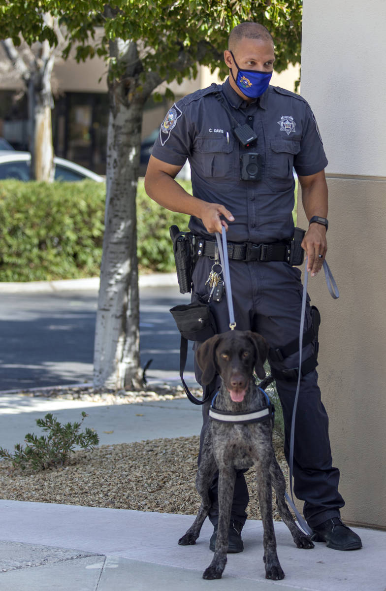 Nevada Highway Patrol Trooper Clifton Davis and Skipper, a German shorthaired pointer, stand fo ...