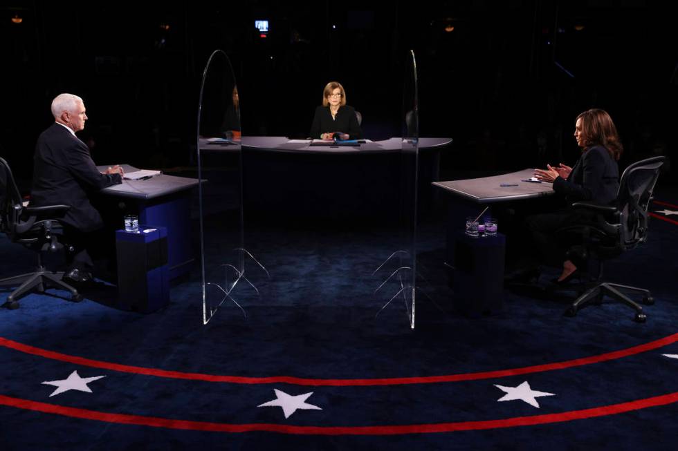 Vice President Mike Pence listens as Democratic vice presidential candidate Sen. Kamala Harris, ...