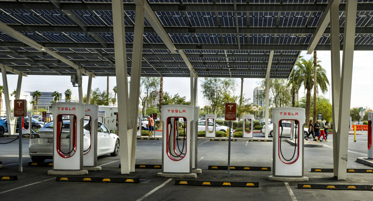 Several cars plug in at the Tesla Supercharger station near The Linq and High Roller on Friday, ...
