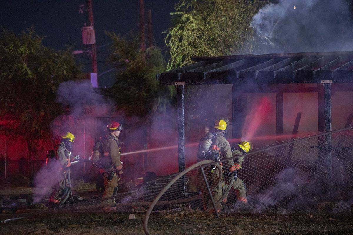 Las Vegas Fire Department firefighters put out a fire that burned a small home at West Cincinna ...