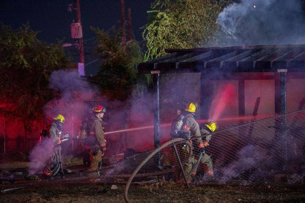 Las Vegas Fire Department firefighters put out a fire that burned a small home at West Cincinna ...
