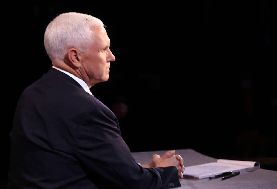 A fly lands on the head of Vice President Mike Pence during the vice presidential debate Wednes ...