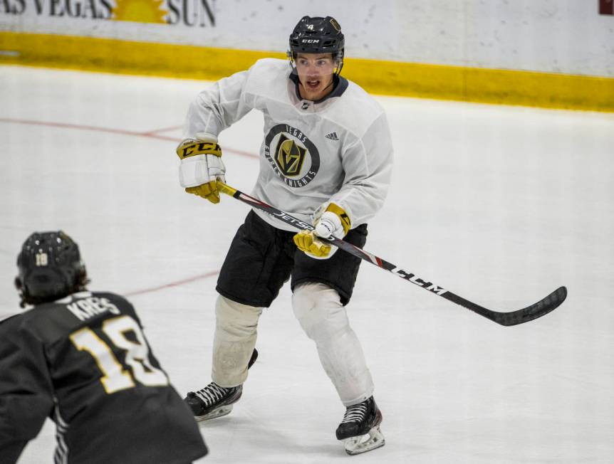 Vegas Golden Knights defenseman Jimmy Schuldt (4, right) looks for a pass beyond left wing Peyt ...