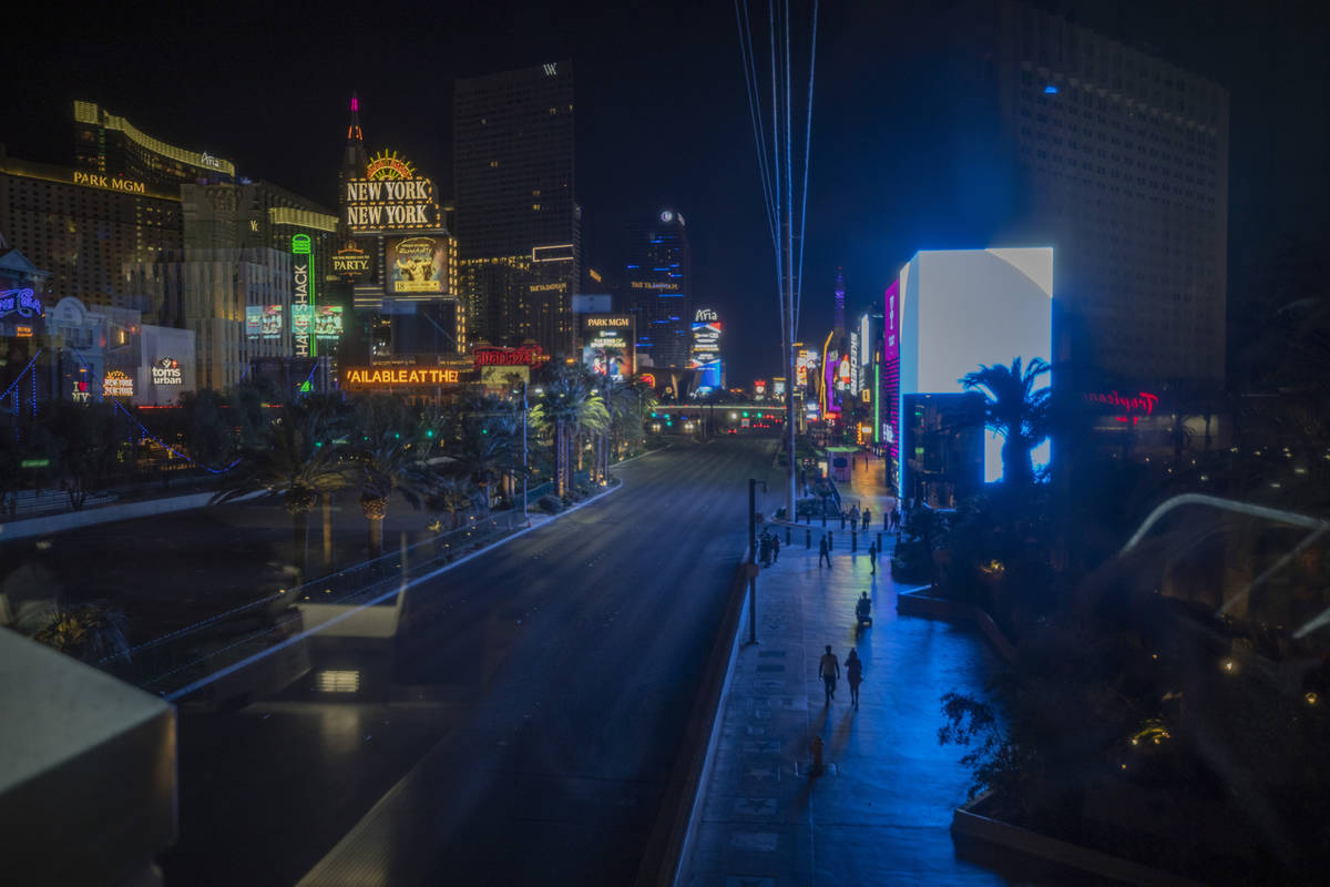 Individuals walk the Las Vegas Strip, early Thursday, Oct. 8, 2020. (Elizabeth Brumley/Las Vega ...