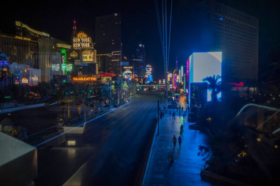 Individuals walk the Las Vegas Strip, early Thursday, Oct. 8, 2020. (Elizabeth Brumley/Las Vega ...