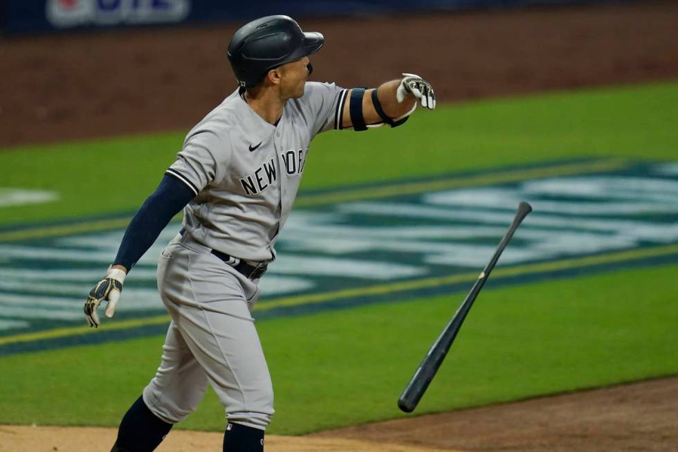 New York Yankees' Giancarlo Stanton tosses his bat after he hit a three-run home run to score L ...