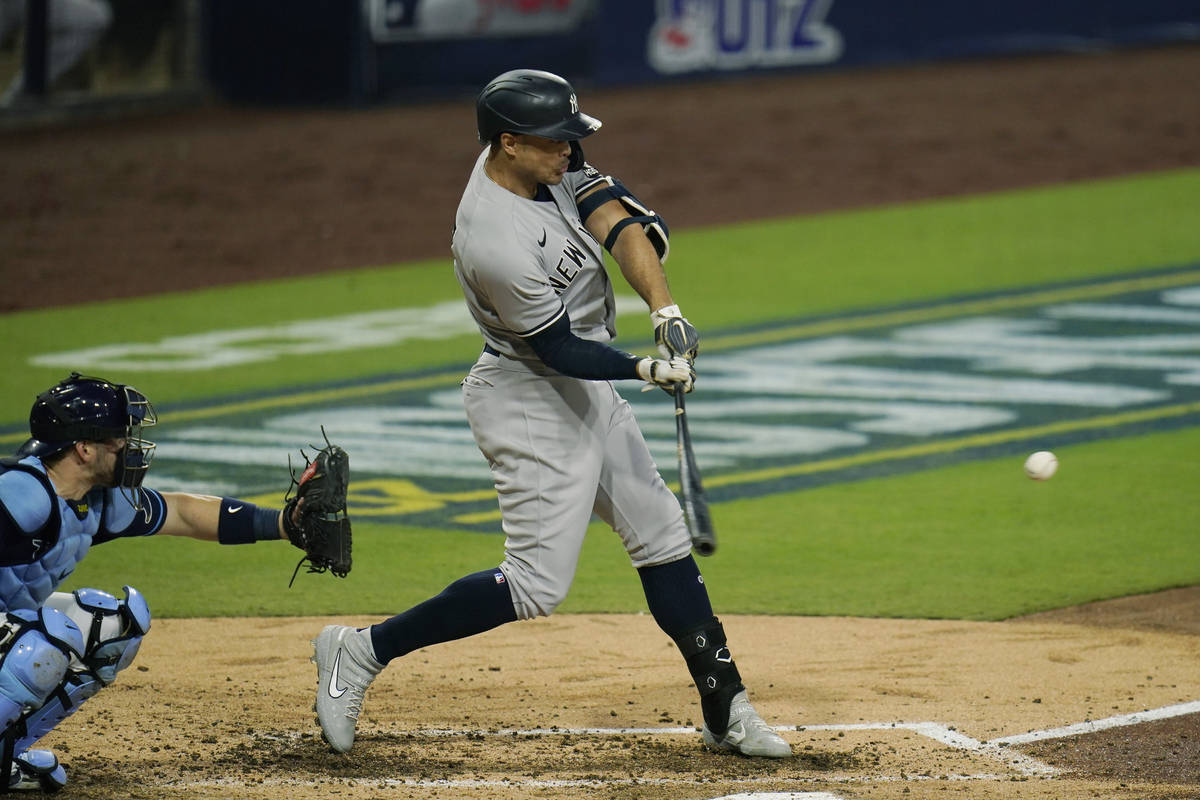 New York Yankees' Giancarlo Stanton hits a three-run home run to score Luke Voit and Aaron Hick ...