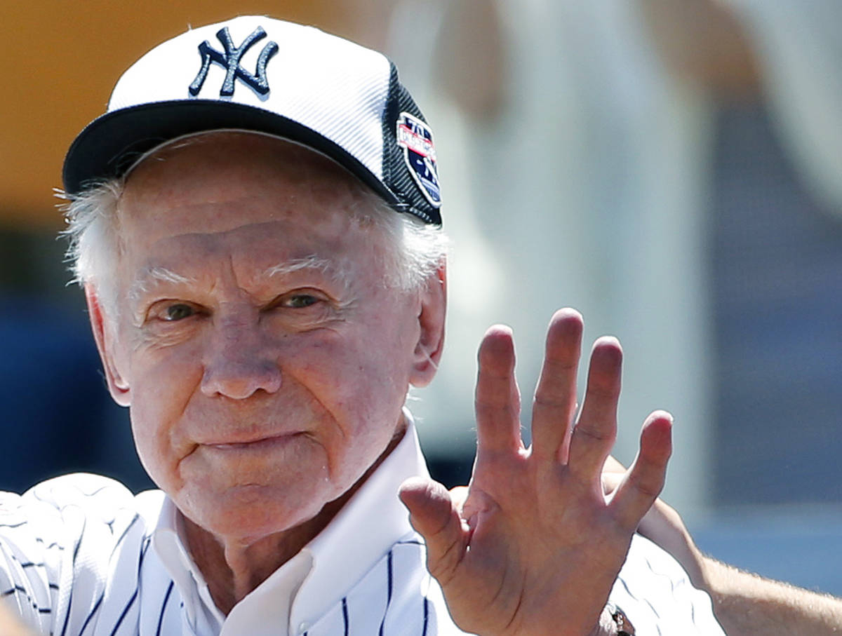 FILE - In this June 12, 2016 file photo, former New York Yankees pitcher Whitey Ford waves to f ...