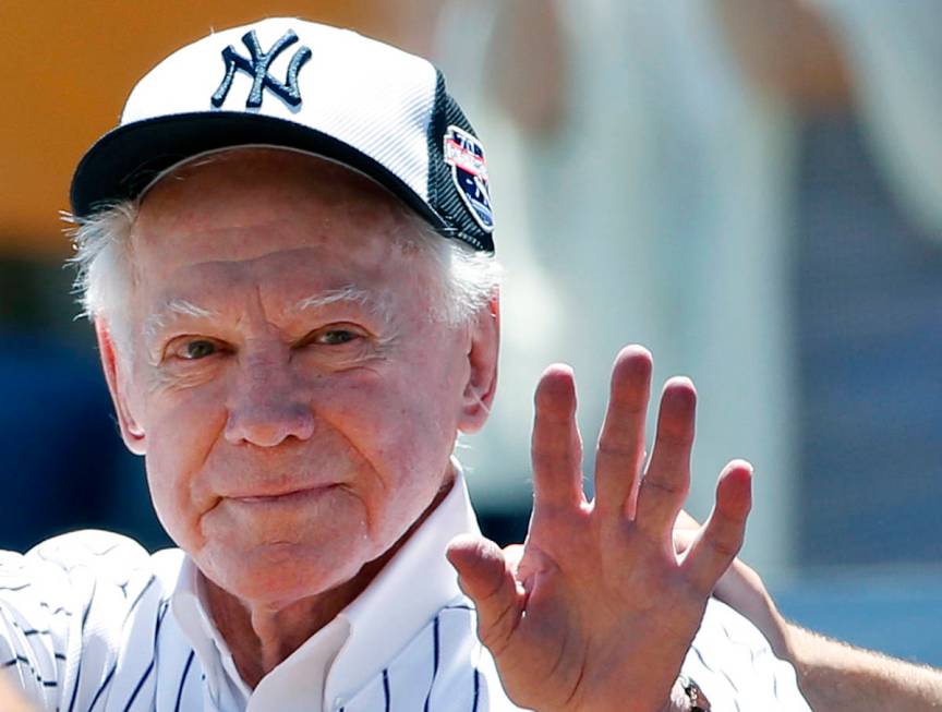 FILE - In this June 12, 2016 file photo, former New York Yankees pitcher Whitey Ford waves to f ...