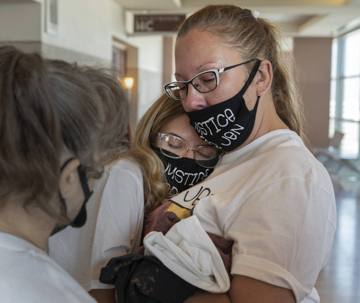 Victim Jennifer Ratay’s daughter, Kelsi Jackson, 16, center, is comforted by family friends C ...