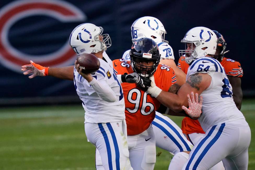 Indianapolis Colts quarterback Philip Rivers (17) throws while being pressured by Chicago Bears ...
