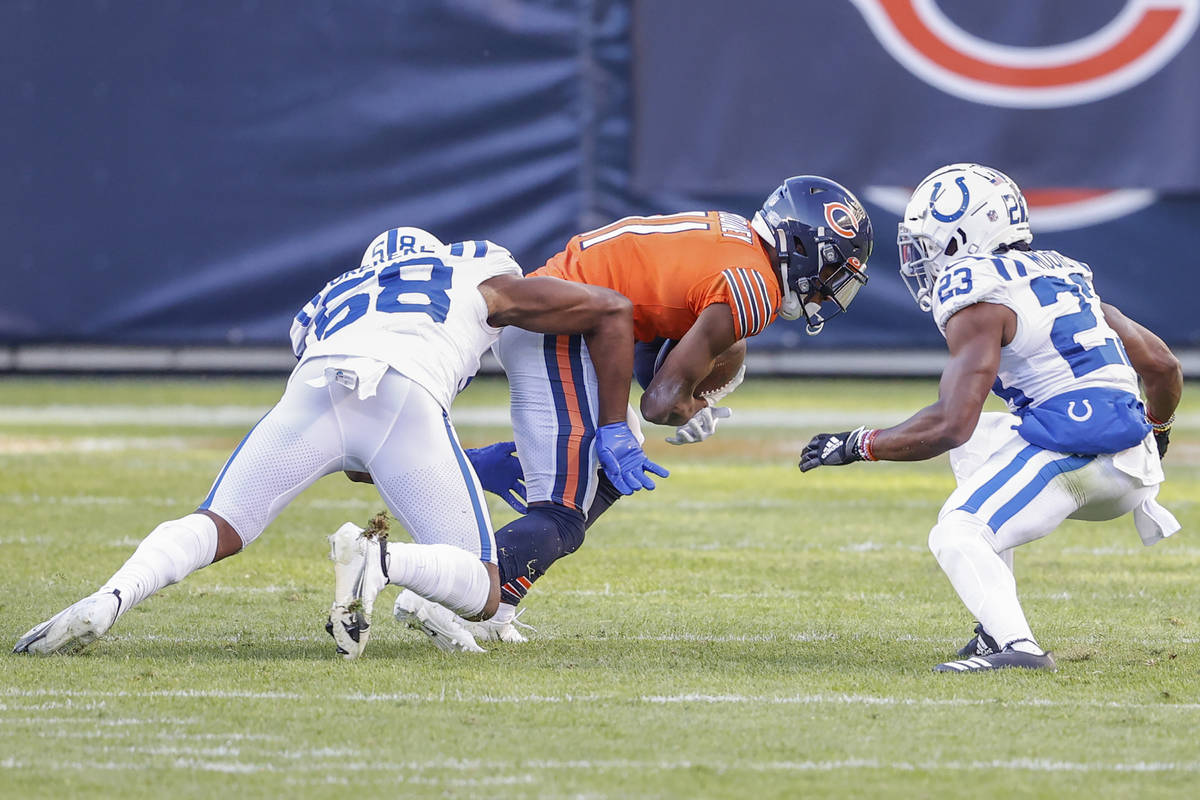 Chicago Bears wide receiver Darnell Mooney (11) is tackled by Indianapolis Colts inside linebac ...