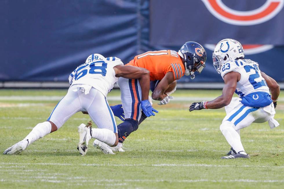Chicago Bears wide receiver Darnell Mooney (11) is tackled by Indianapolis Colts inside linebac ...