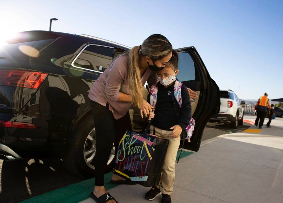 Jessica Hood kisses her daughter, Naomi, 5, kindergarten student, after dropping her off at Leg ...