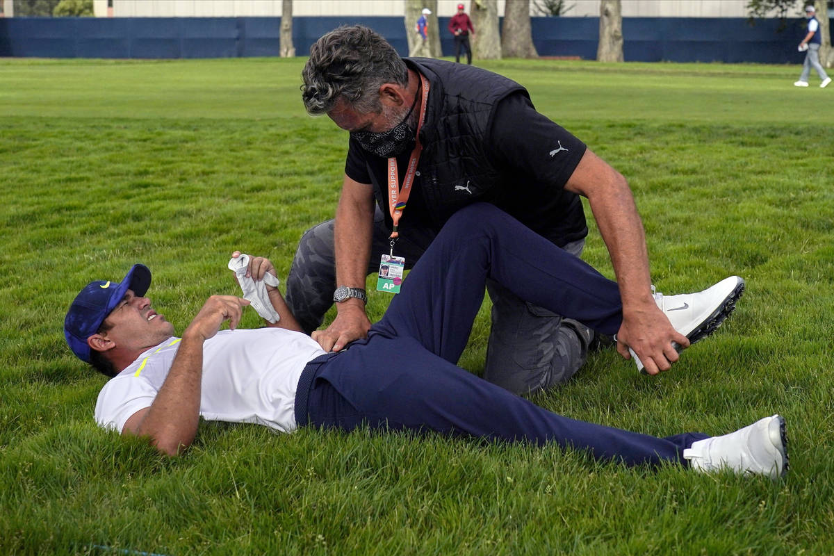 FILE - Brooks Koepka gets treated for an injury on the 12th hole during the second round of the ...