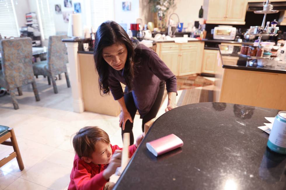 Prem Premsrirut gets her son Ivan, 7, ready for school at their Las Vegas home Monday, Sept. 28 ...