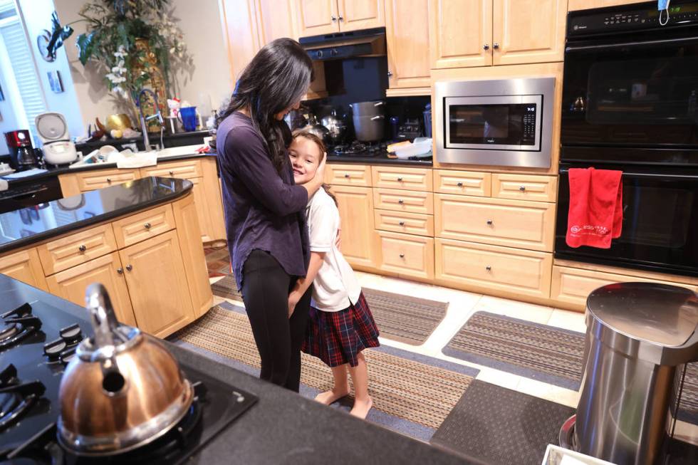 Prem Premsrirut gets her daughter Anya, 9, ready for school at their Las Vegas home Monday, Sep ...