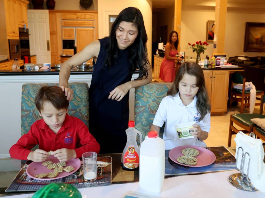 Prem Premsrirut gets her children Ivan, 7, left, and Anya, 9, ready for school at their Las Veg ...