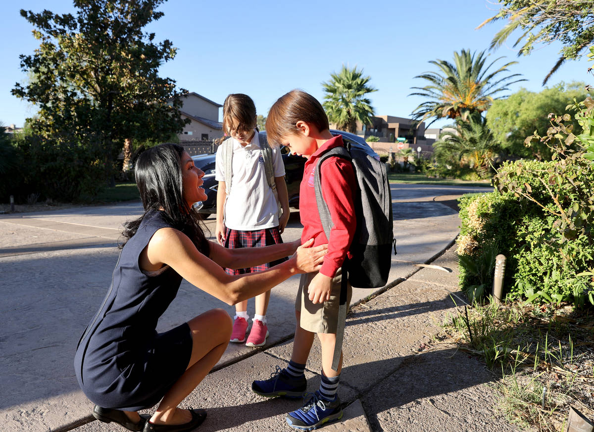 Prem Premsrirut gets her children Anya, 9, left, and Ivan, 7, ready for school at their Las Veg ...