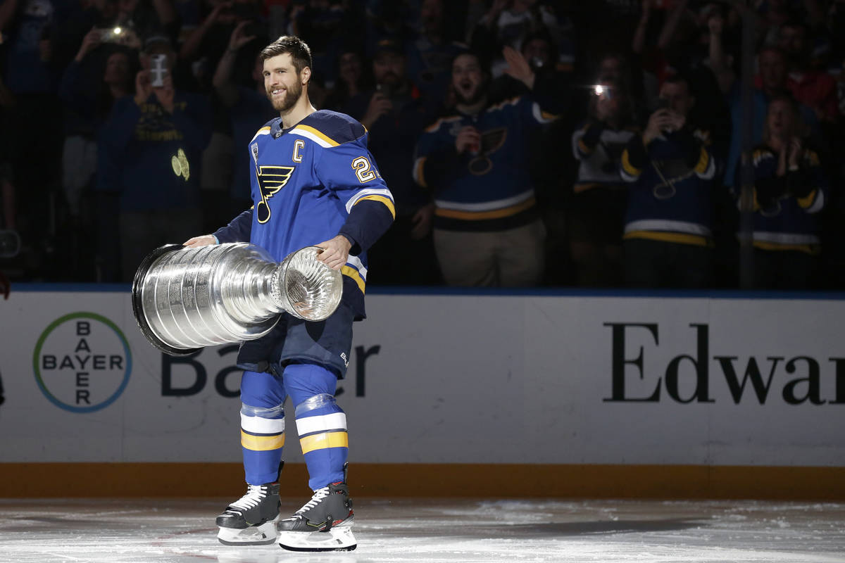 St. Louis Blues captain Alex Pietrangelo lifts the Stanley Cup during a ceremony honoring the B ...