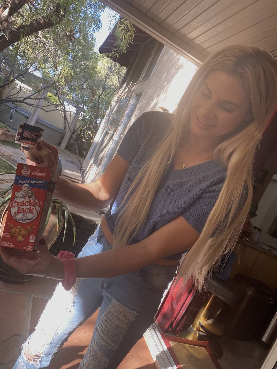 Dani Elizabeth shows off her Cracker Jack box containing her engagement ring from Murray Sawchu ...